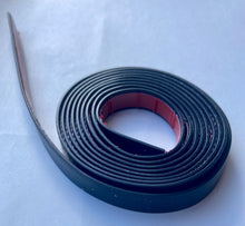 Load image into Gallery viewer, A coiled length of black tungsten tape with a red adhesive backing.
